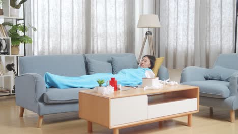 woman sleeping on couch, sick at home