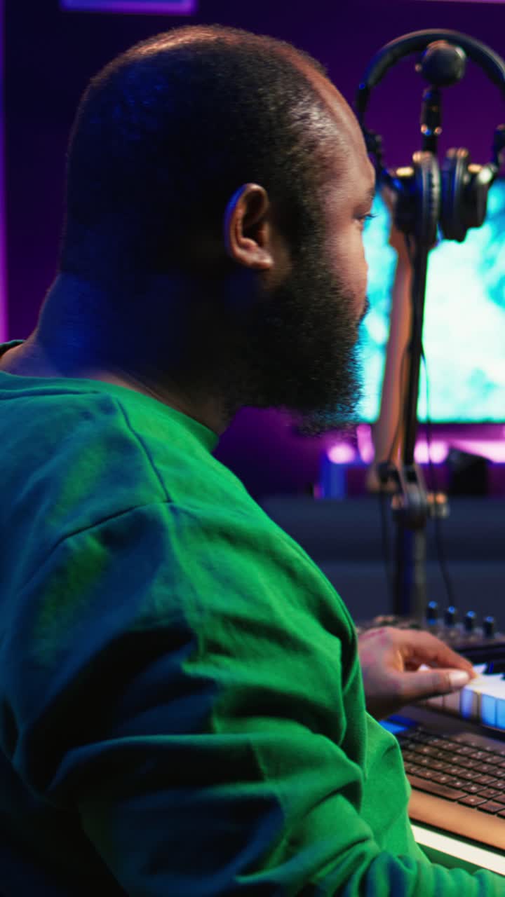 African American Music Producer Playing MIDI Keyboard in Home Studio