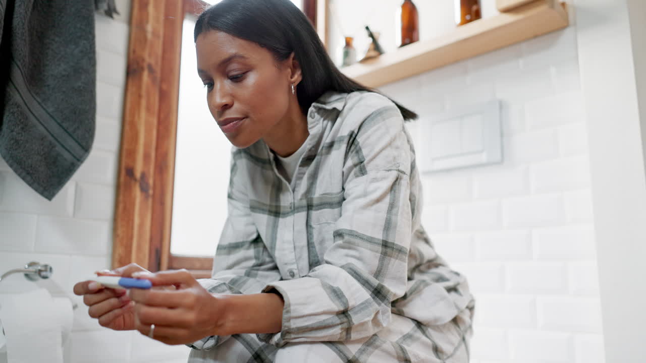 Worried, woman and pregnancy test in bathroom