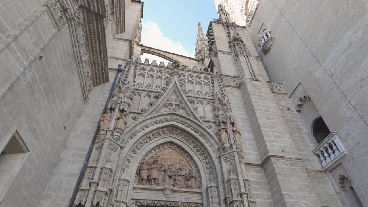 Ornate Gothic entrance of Seville Cathedral with intricate stone carvings in Spain