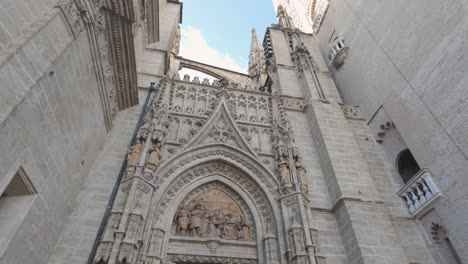 ornate gothic entrance of seville cathedral with intricate stone carvings in spain