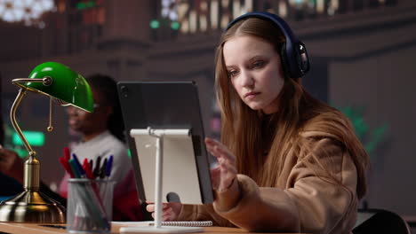 Vertical video young female adult listening to therapy music and working on her bachelor paper