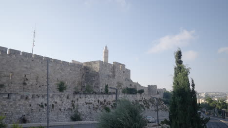 ancient walls of jerusalem and david's tower at background in old city of jerusalem, israel. panning shot