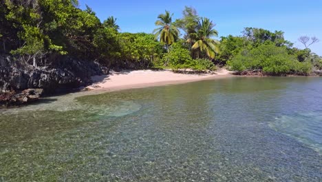 Hidden-empty-beach-at-Playa-Ermitano-with-shallow-sea-water,-Dominican-Republic