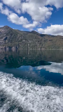 lago lacar quila quina boat ride with mountains reflecting in the serene lake