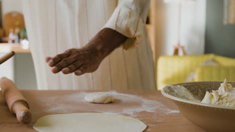 man making flatbread at home