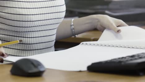 woman working on paperwork at desk