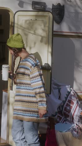 woman enjoying coffee outside a camper van