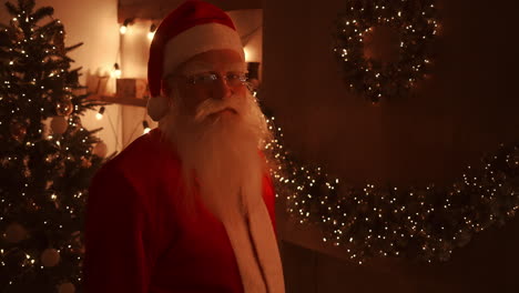 On-Christmas-night-Santa-delivers-gifts-to-homes-while-everyone-is-asleep.-Santa-will-leave-gifts-under-the-Christmas-tree-in-the-decorated-house.-High-quality-4k-footage