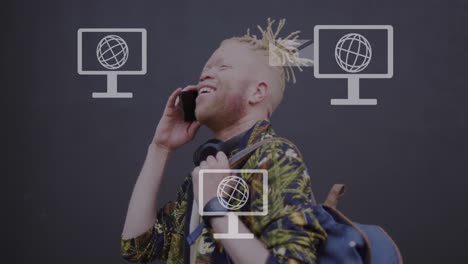 animation of screens with globes over albino african american man with smartphone