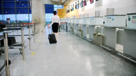 airline check-in attendant walking with luggage 4k