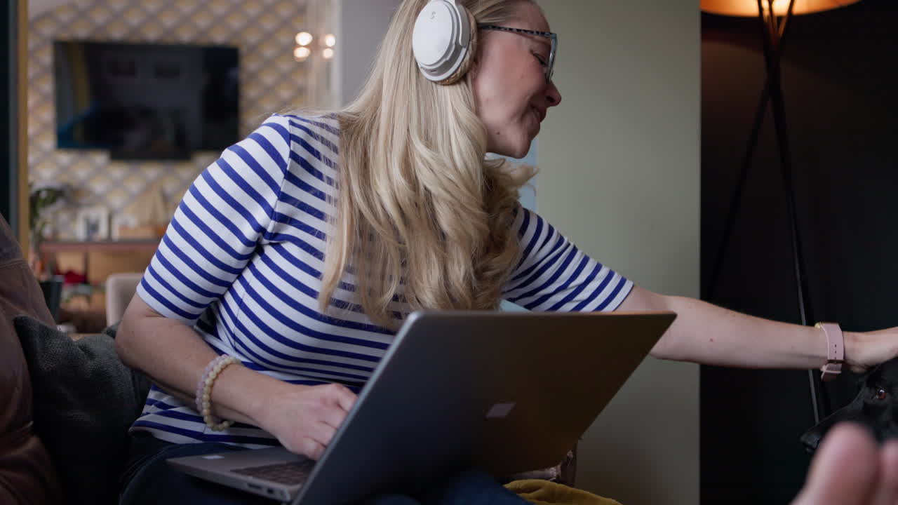Woman working on laptop with her dog