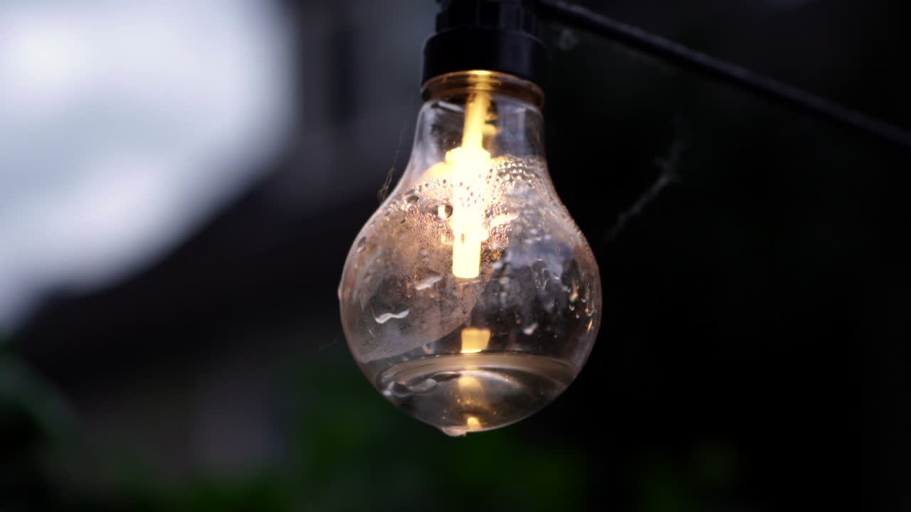 Garden lamp on a string moving in the wind