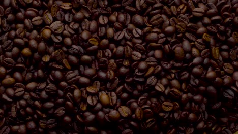 4k footage. 4096x2304p.fragrant coffee beans are roasted in a frying pan, smoke comes from coffee beans. the whole composition scrolls slowly around the camera. scoop stir coffee beans.