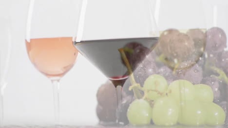 composite of glasees with white, rose and red wine glasses over grapes on white background