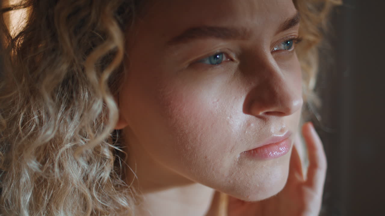 Contemplative woman touching face looking mirror. Closeup smiling girl admiring