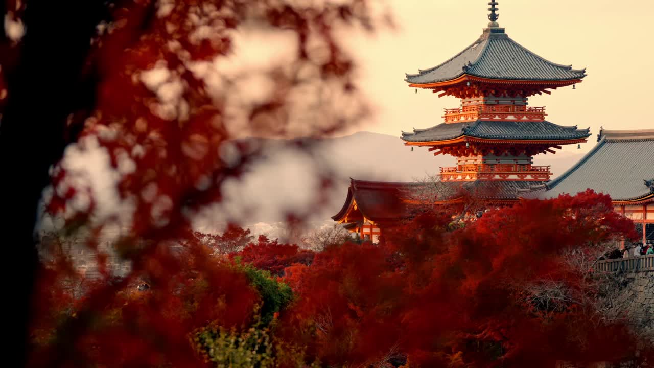 A mesmerizing view of Kiyomizu-dera Temple in Kyoto, Japan, bathed in the warm glow of sunset.