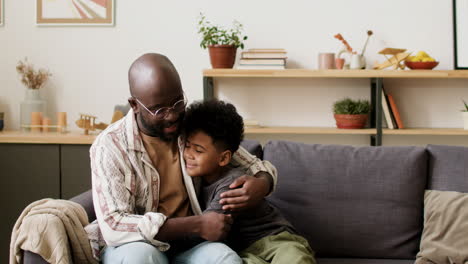 father and son hugging in the living room