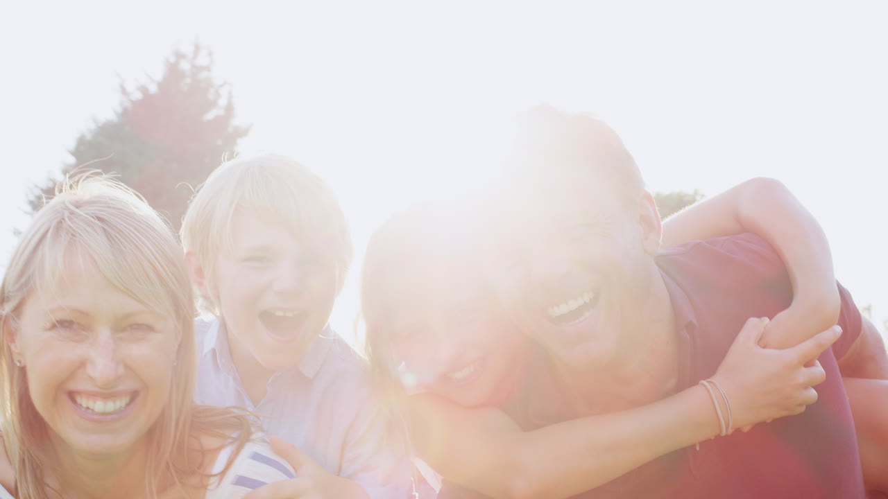 정원에서 카메라에 미소 짓는 네 명의 가족, 가 ⁇ 게