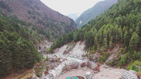 a pristine himalayan river winds through vibrant green mountains, offering a peaceful and refreshing view of untouched nature.