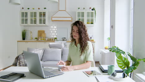 woman sitting at desk in the living room