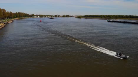 Aerial-View-Of-Fast-Speedboat-Travelling-Along-Oude-Maas