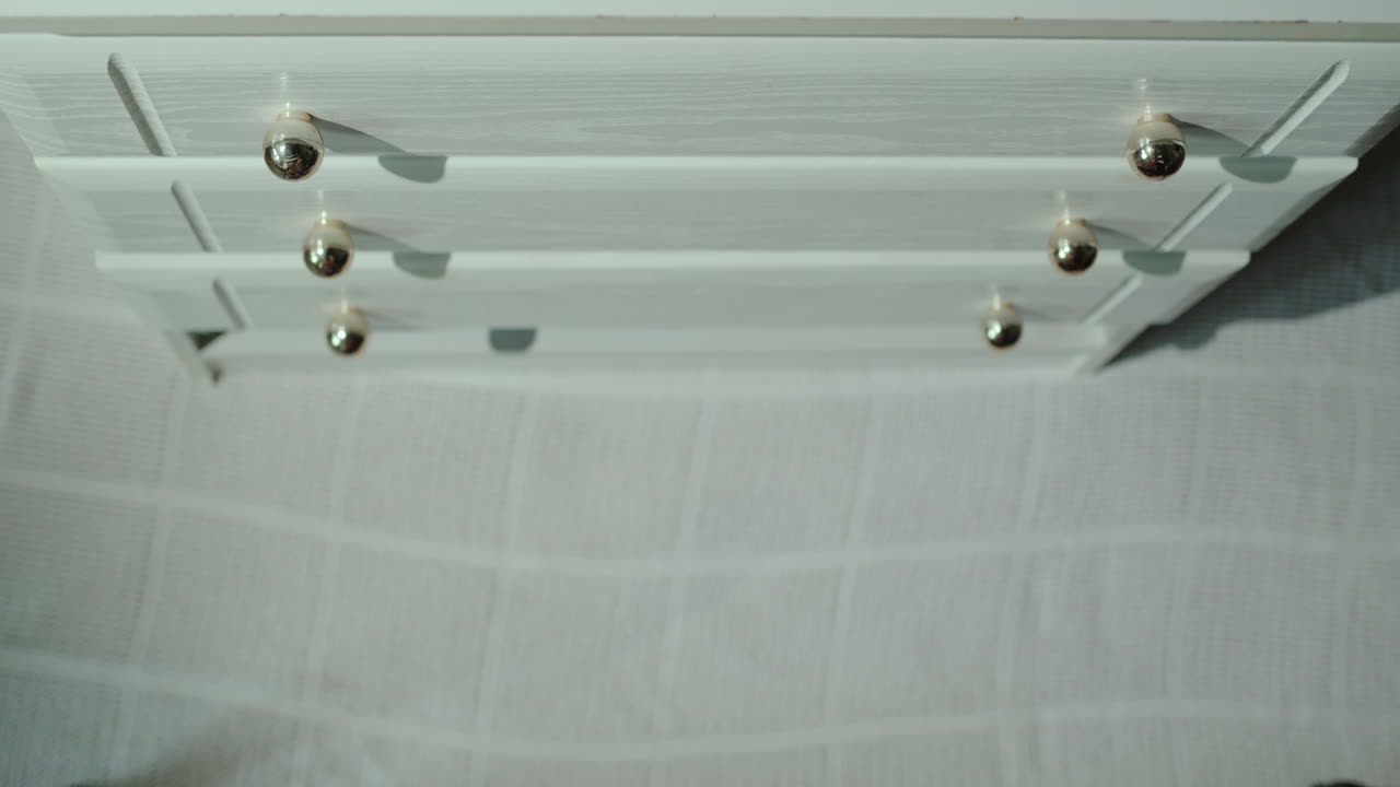 Man opens drawer with shirts