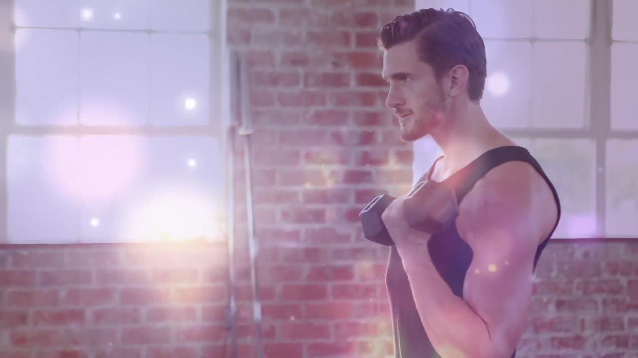 Animation of bokeh effect against caucasian young man building muscles with dumbbell in gym