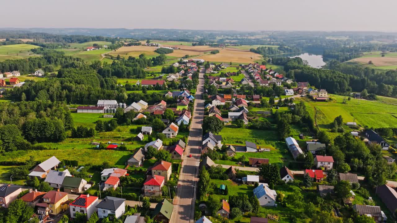 Aerial panorama of Filipów village with houses, fields, winding horizon views