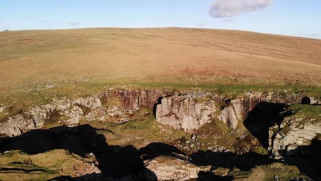 Aerial-view-flying-over-granite-rocks-at-Foggintor-Quarry-Dartmoor,-Devon