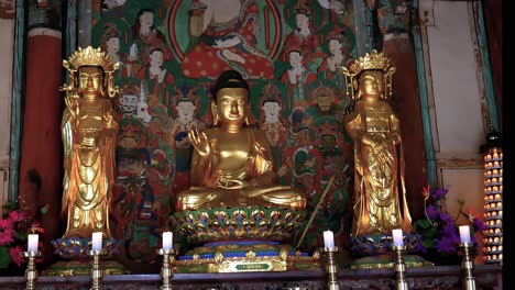 inside korean temple with golden buddha statue