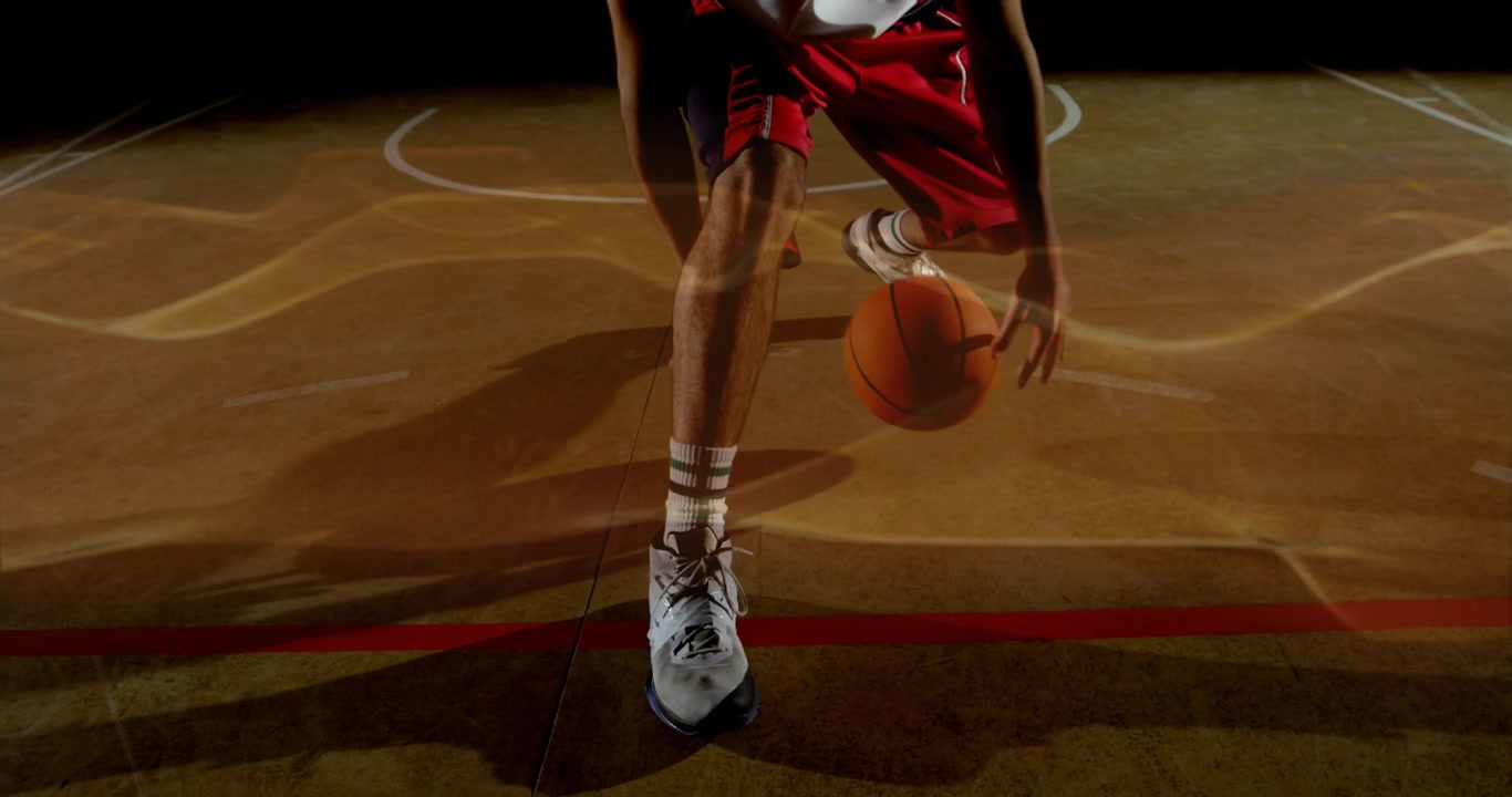 Giocatore di basket che esegue un palleggio incrociato in campo per l'allenamento sportivo, con onde dorate pulsanti.
