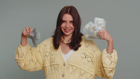 rich pleased boss woman waving money dollar cash, success business career, lottery winner big income