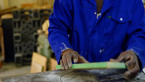 worker working at table in foundry workshop 4k