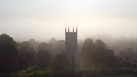 drone shot orbiting islip church in mist 03