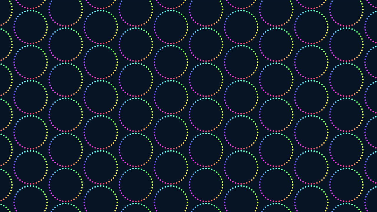 Colorful circles varying in size are arranged in a circular pattern against a dark background in the image