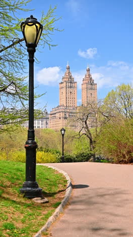 spring skyline over central park. stroll through central park enjoying vibrant greenery and fantastic views of iconic skyscrapers on a sunny day