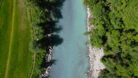 aerial top down view of turquoise river in zernez of switzerland national park during summer