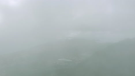 drone flying through clouds over pico do facho in portugal