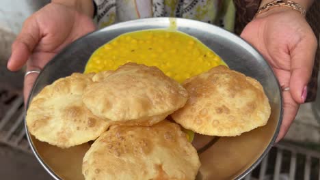 profile view of luchi and cholar dal served by roadside stall in kolkata, india