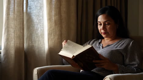 woman reading a book indoors
