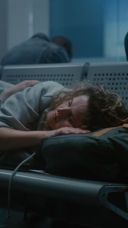 woman sleeping in airport lounge