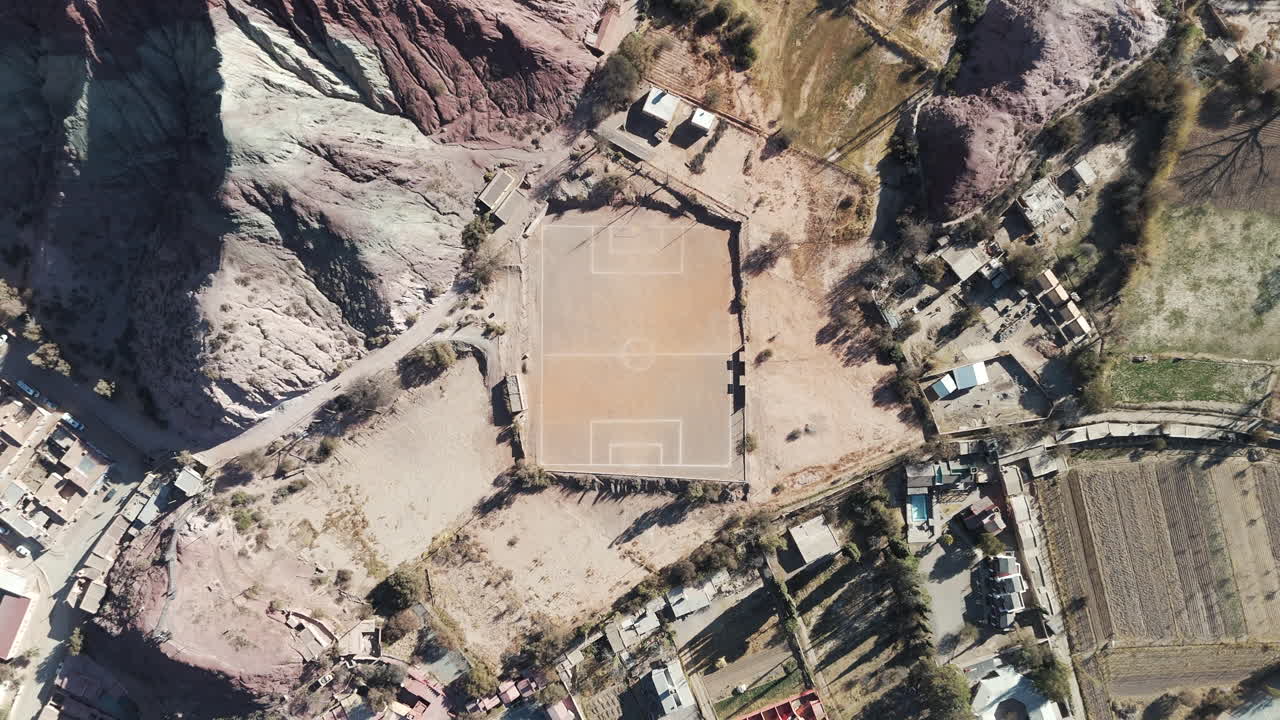 Small football field in the heart of Purmamarca, Jujuy desert, viewed from above by a drone.