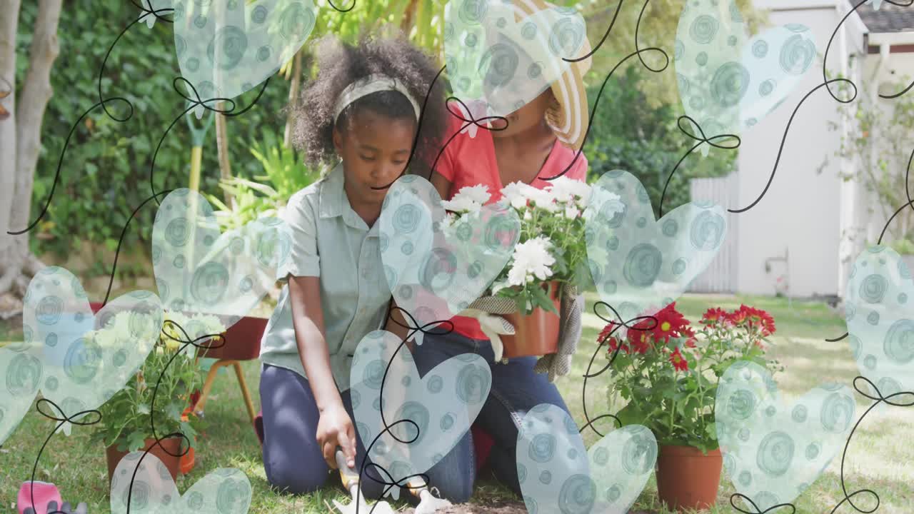 Animación de globos de corazón sobre madre e hija afroamericanas felices cultivando plantas