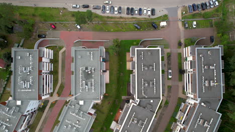 Top-down-aerial-view-of-the-roof---residential-buildings---modern-apartment-blocks---situated-along-the-street