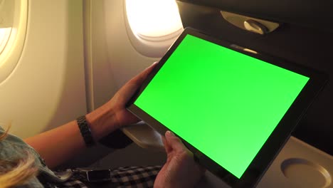 working with laptop tablet pc on aircraft,green screen and chroma key.