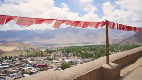 view of leh city with prayer flags from leh palace or fort with backdrop of upper himalayas landscape in ladakh india