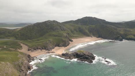 Drone-shots-capturing-the-turquoise-waters-of-Murder-Hole-Beach,-creating-a-stunning-contrast-against-the-golden-sand