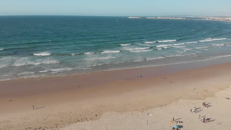 aerial view of the beach with surfers in west coast of portugal in baleal, peniche