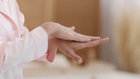 close-up of hands applying lotion or moisturizer